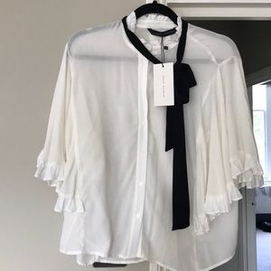 White blouse with black tied collar